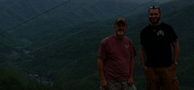 Neal, Tim 2016 with Chris at beginning of Mason Jar Town of Evarts KY in background April 30.jpg
